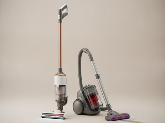 Upright corded vacuum with copper pole and rectangular brush head next to canister vacuum with hose and carpet cleaning attachment.